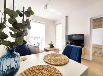 a living room with a table with a vase on it at Mogilska 120D by Homeprime in Kraków
