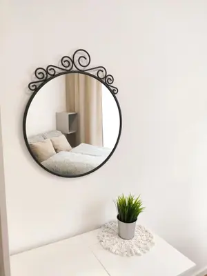 a mirror on a white wall above a white table at Mogilska 120D by Homeprime in Kraków