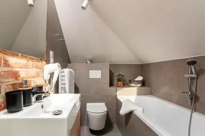 a hotel room with a bed and a brick wall at Felicjanek 15 - by Upstairs in Kraków