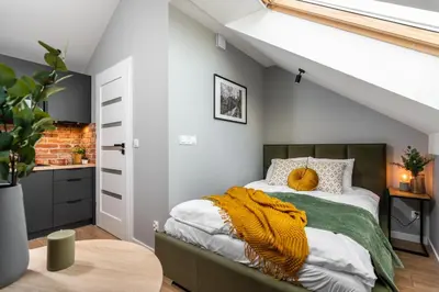 a bedroom with a bed with a yellow blanket on it at Felicjanek 15 - by Upstairs in Kraków