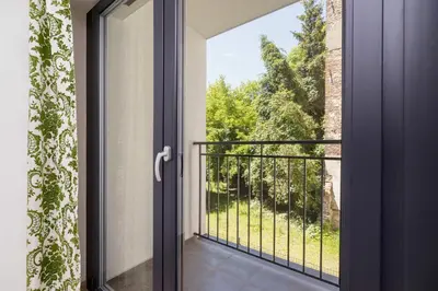 an open door to a balcony with a view at Śródmieście Kątowa Air-conditioned Studio Kraków by Noclegi Renters in Kraków