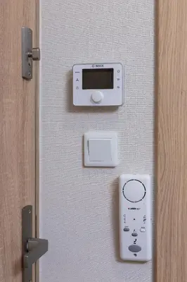 a door with a remote control next to a door at Śródmieście Kątowa Air-conditioned Studio Kraków by Noclegi Renters in Kraków