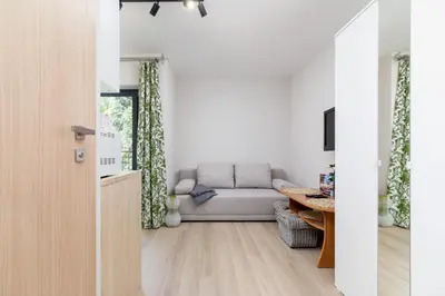 a living room with a couch and a table at Śródmieście Kątowa Air-conditioned Studio Kraków by Noclegi Renters in Kraków