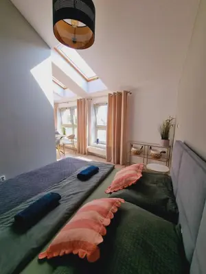 a bedroom with a bed with pillows on it at Apartament Miodowa Street PARKING FREE in Kraków