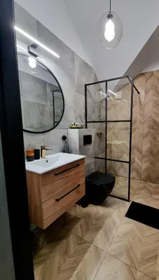 a bathroom with a sink and a mirror at Apartament Miodowa Street PARKING FREE in Kraków