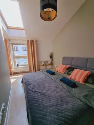 a bedroom with a large bed with orange pillows at Apartament Miodowa Street PARKING FREE in Kraków