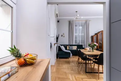 a kitchen and living room with a table and a dining room at Old Town Luxury Apartment - Rynek Szewska in Kraków