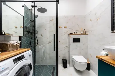 a bathroom with a washing machine and a sink at Old Town Luxury Apartment - Rynek Szewska in Kraków