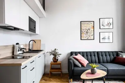 a living room with a couch and a table at Charming Studio with kitchen - Old Town, Main Station in Kraków