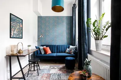 a living room with a blue couch and a table at Charming Studio with kitchen - Old Town, Main Station in Kraków