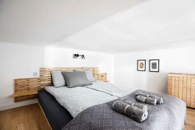 a bedroom with a bed with two stuffed animals on it at Charming Studio with kitchen - Old Town, Main Station in Kraków