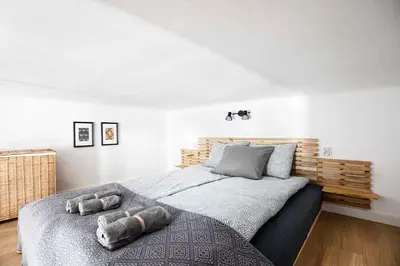 a bedroom with a bed with two stuffed animals on it at Charming Studio with kitchen - Old Town, Main Station in Kraków