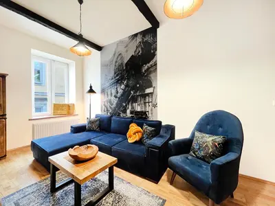 a living room with a blue couch and two chairs at 2-room Apartment with kitchen, heart of Cracow Old Town in Kraków