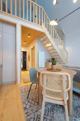a dining room with a table and a staircase at Beskidzkie Super Stodoły in Zawoja