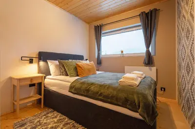 a bedroom with a large bed with a window at Beskidzkie Super Stodoły in Zawoja