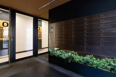 an office lobby with a plant wall at Fredry 6 Apartment Premium Łagiewniki by Renters Prestige in Kraków