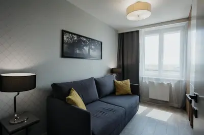 a living room with a blue couch and a window at Sky Mountain View Free Parking in Kraków