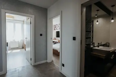 a bathroom with a sink and a bedroom at Sky Mountain View Free Parking in Kraków