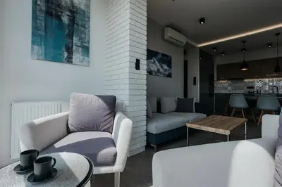 a living room with a couch and a table at Sky Mountain View Free Parking in Kraków