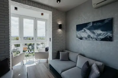 a living room with a couch and a large window at Sky Mountain View Free Parking in Kraków