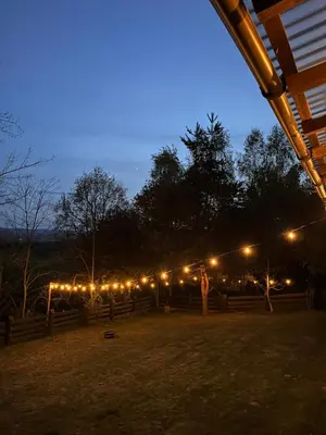 a row of lights on a fence at night at Izdebka na Podchybiu in Izdebnik