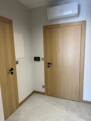an empty room with two wooden doors and a heater at Apartamenty WIERCHY in Klikuszowa