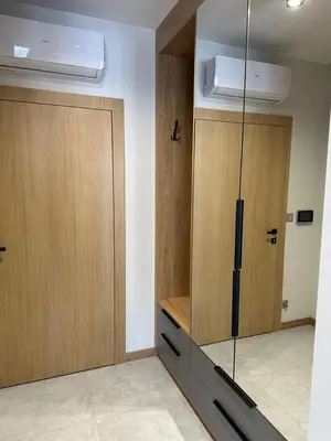 a room with two wooden cabinets and a door at Apartamenty WIERCHY in Klikuszowa