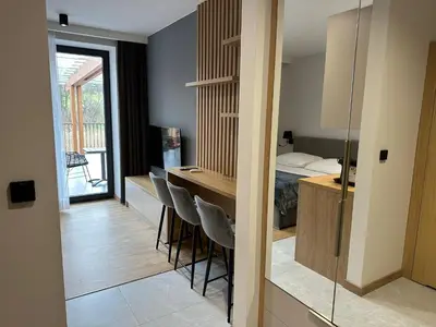 a room with a bed and a table and chairs at Apartamenty WIERCHY in Klikuszowa