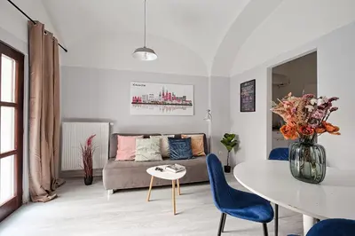 a living room with a couch and a table at Urban Nest Apartments Party Szewska21 in Kraków