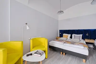 a bedroom with a bed and a table and chairs at Urban Nest Apartments Party Szewska21 in Kraków