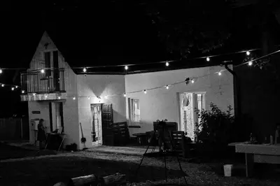 a string of lights over a house at night at Zaczarowana Furmanka in Antolka