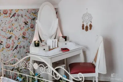 a white dressing table with a mirror and a chair at Zaczarowana Furmanka in Antolka