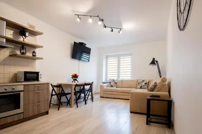 a living room with a couch and a table at THE SOUL of Nowa Huta - free garage in Kraków