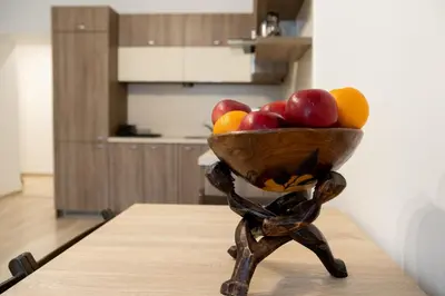 a wooden bowl of fruit sitting on a table at THE SOUL of Nowa Huta - free garage in Kraków