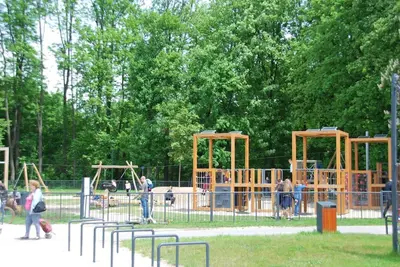 a playground in a park with people walking around it at THE SOUL of Nowa Huta - free garage in Kraków