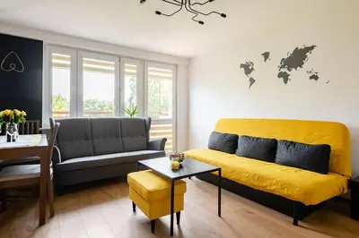 a living room with a couch and a table at The Best Location in Cracow for City Break in Kraków