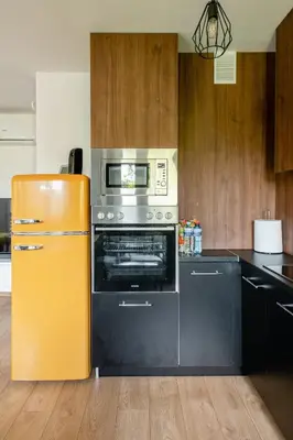 a kitchen with a yellow refrigerator and a stove at The Best Location in Cracow for City Break in Kraków
