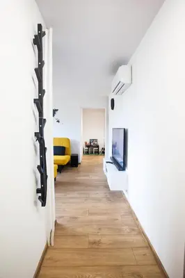 a hallway with white walls and a tv on a wall at The Best Location in Cracow for City Break in Kraków