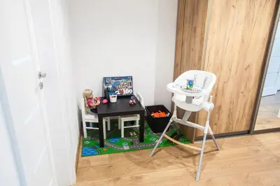 a toy room with a table and a stool at The Best Location in Cracow for City Break in Kraków