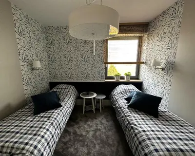 a living room with two couches and a window at Apartament Pod Ojcowem in Skała