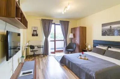 a bedroom with a bed and a tv and a window at Przytulny apartament z parkingiem blisko Tauron Areny in Kraków