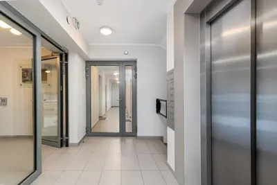 a hallway with glass doors in a building at Zabłocie Apartment Best Location to Explore Krakow in Kraków