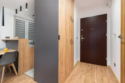 a room with a door and a table and a desk at Romanowicza Prestige Place in Kraków
