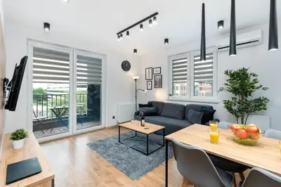 a living room with a couch and a table at Romanowicza Prestige Place in Kraków