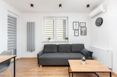 a living room with a couch and a table at Romanowicza Elegant Place in Kraków