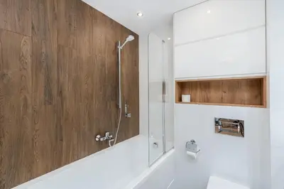 a bathroom with a shower with a glass door at Romanowicza Elegant Place in Kraków