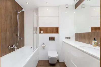 a bathroom with a toilet and a sink and a shower at Romanowicza Elegant Place in Kraków