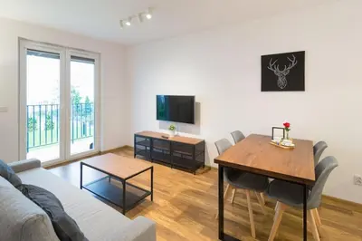 a living room with a couch and a table at Zabłocie Cozy Escape in Kraków