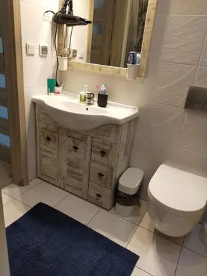 a bathroom with a sink and a toilet and a mirror at TOM ROOM - Cracow City Centre in Kraków