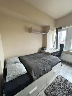 a bedroom with a large bed and a desk at TOM ROOM - Cracow City Centre in Kraków
